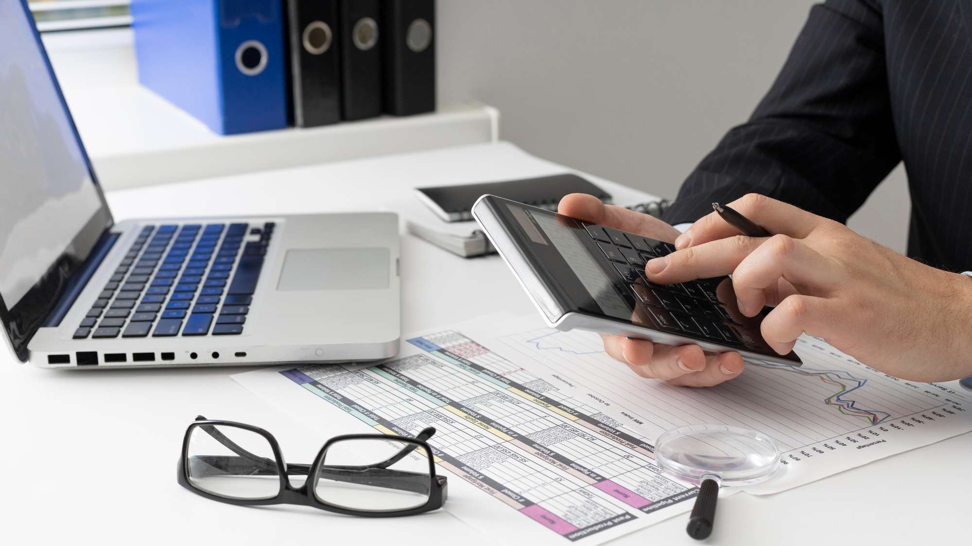 side-view-business-man-calculating-finance-numbers